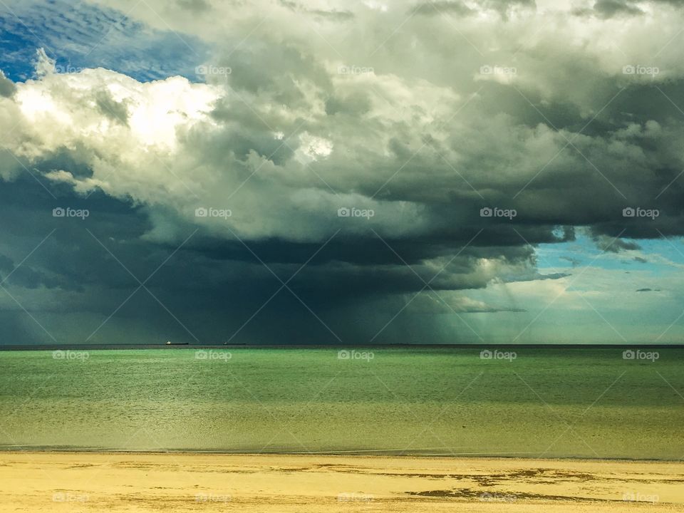 Storm brewing over ocean, dark clouds, rain in distance, south Australia 