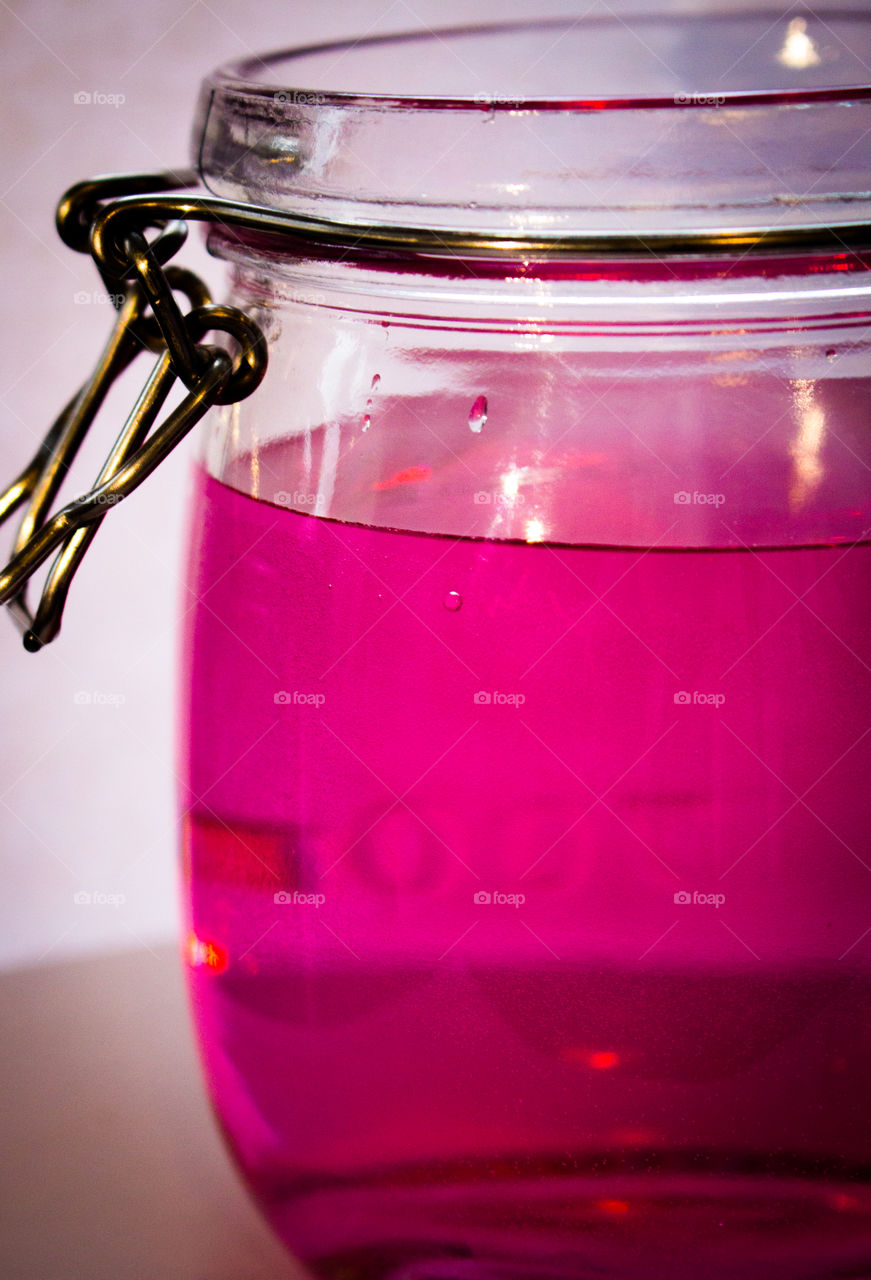 Close-up of pink water in jar