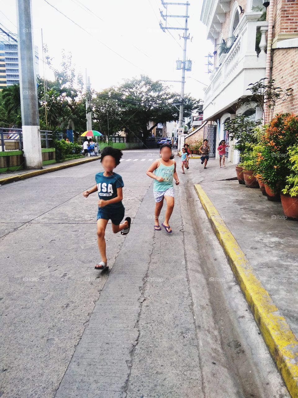 Running kids. They are so happy playing.I wish we could go back to that time. Childhood time is so fun. Happiness don't have to be expensive.