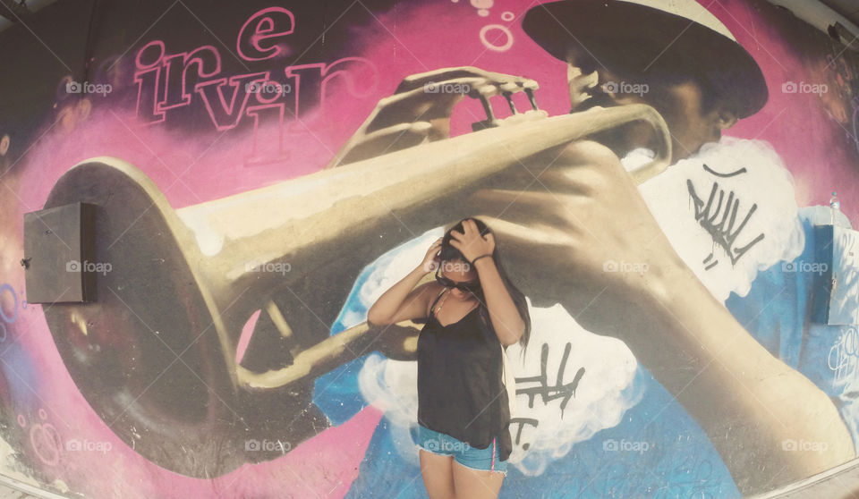 Woman standing against painted wall