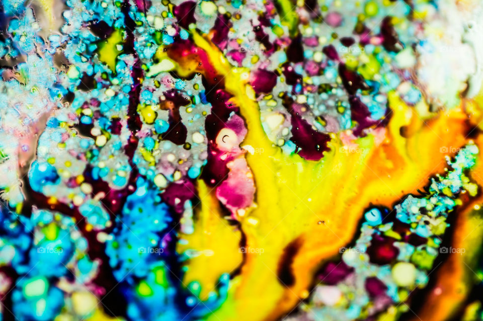 The ink to refill the printer cartridge was spilled onto the white washbasin and the paints blended into abstract drips and patterns.