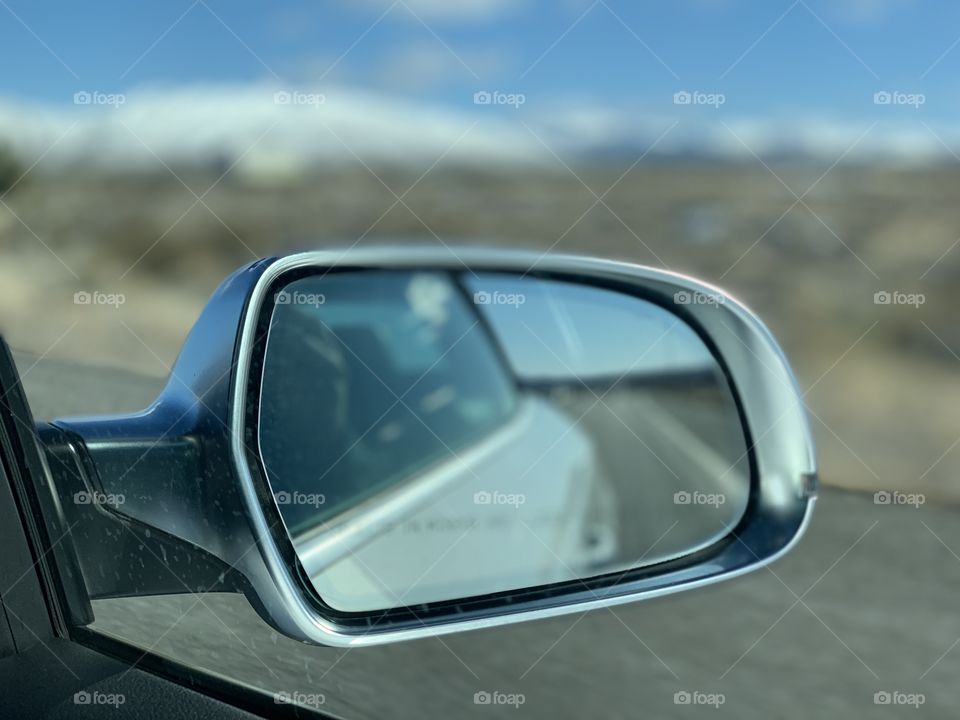 Car road trip rear view mirror looking back travel glass nostalgia sky mountain stainless peak blue reflections happy vibes freedom explore experience 