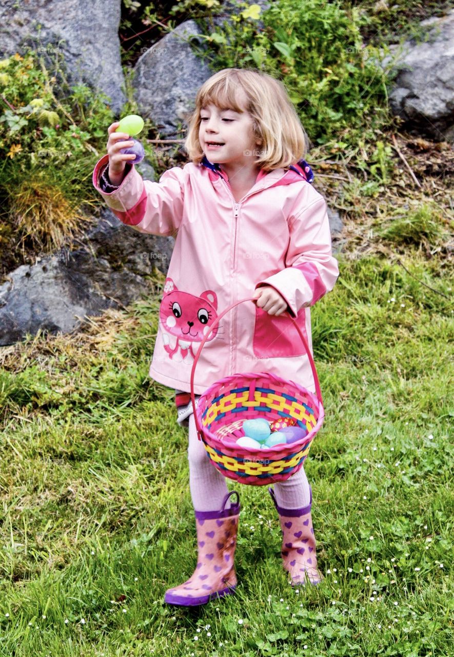 Young girl thrilled and happy to find candy at Easter Egg Hunt