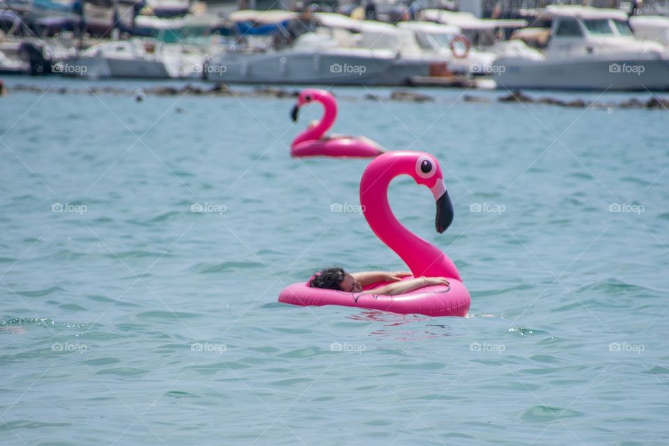 Floating in the ocean on a blow up air flamingo