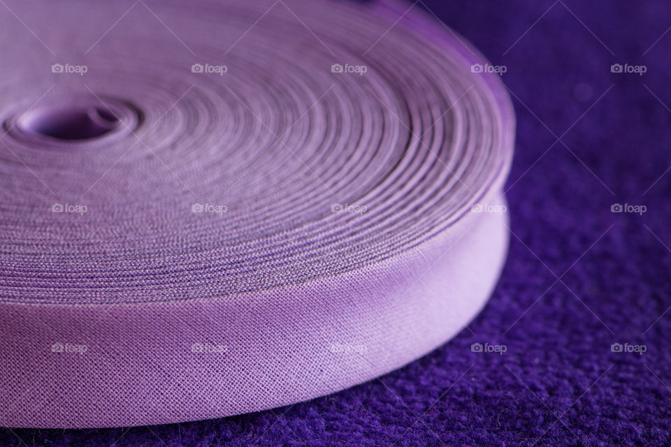 Close up a rolled up violet ribbon