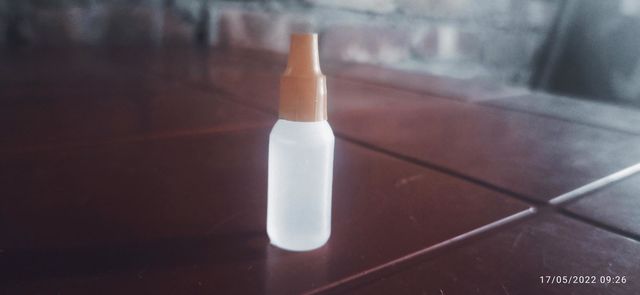 Bottled drops enlightened on table