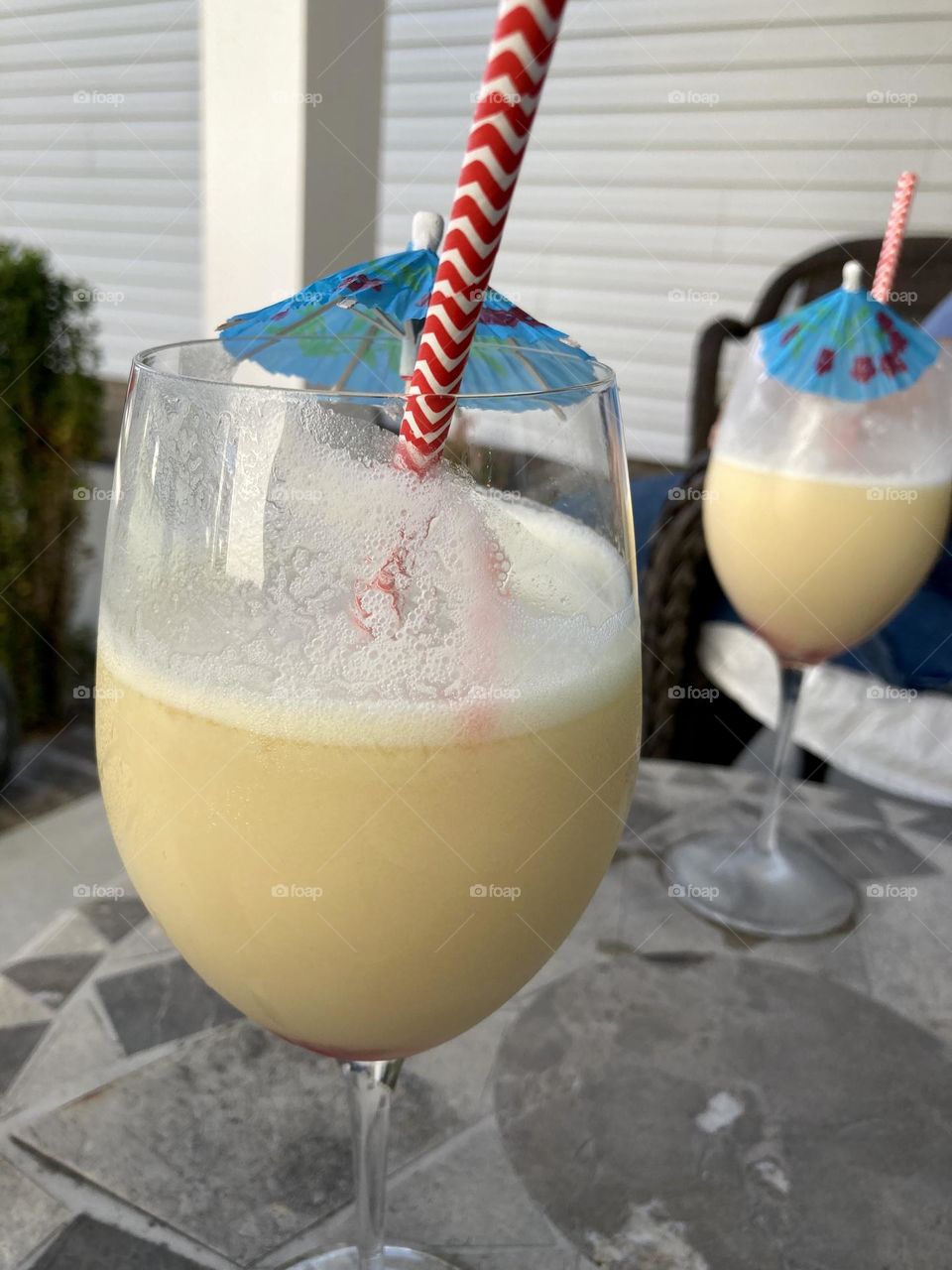 Drink with blue umbrella and red striped straw