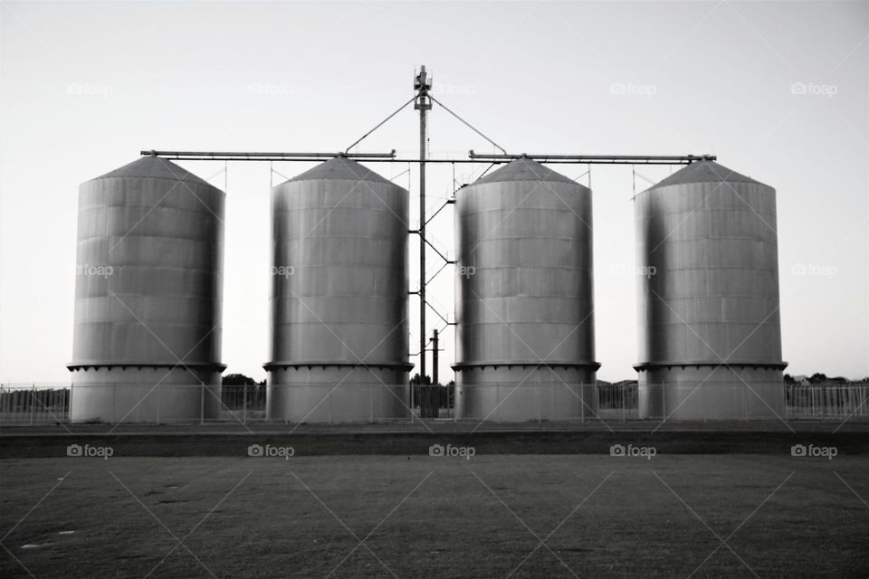 Old grain silos stand tall in a Arizona field