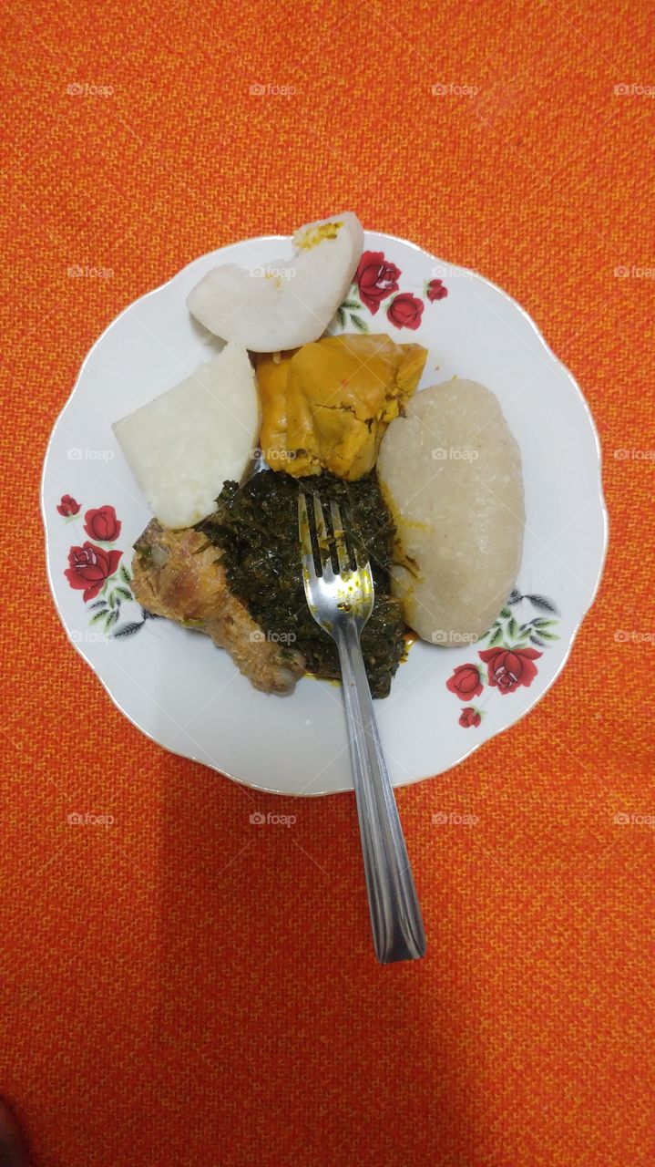food mixture (yams, chicken, "koki", "fufu and eru")