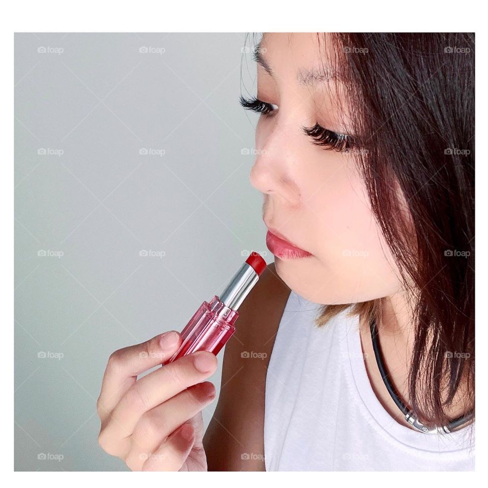 Asian woman in Korean bright red lipstick with cute details 
