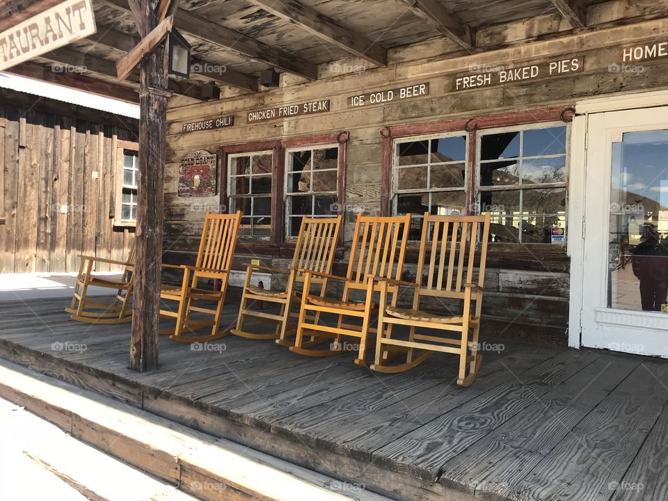Rocking chairs in front of western restaurant 
