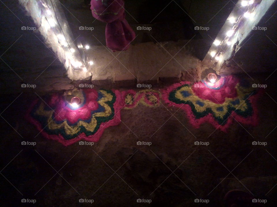 Decoration of rangoli and oil lamp during Diwali in front of house