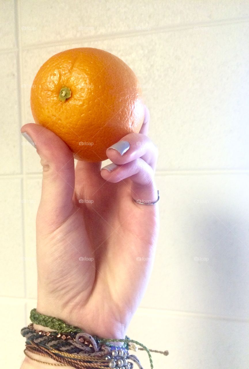 Hand and orange 