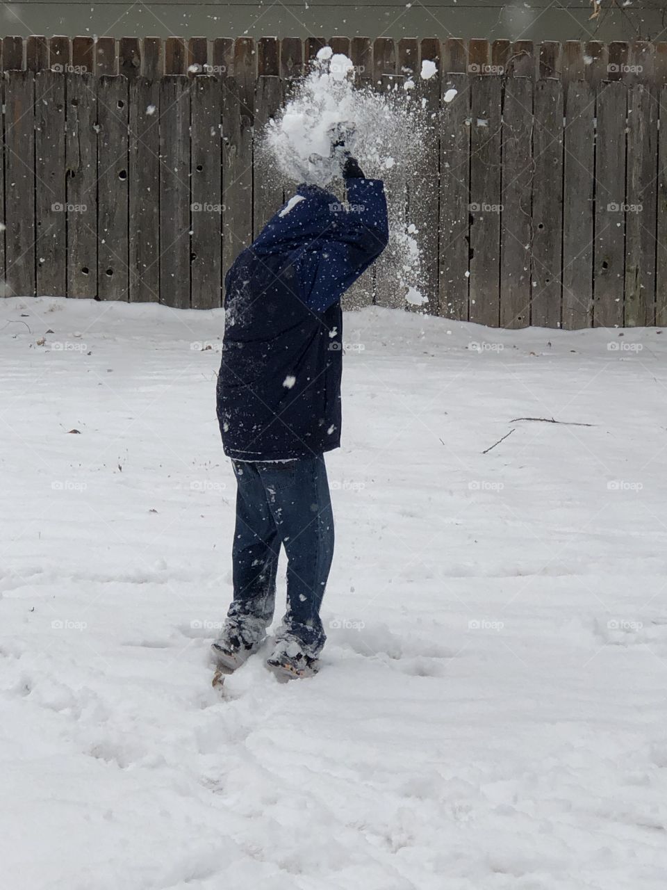 Child tossing snow