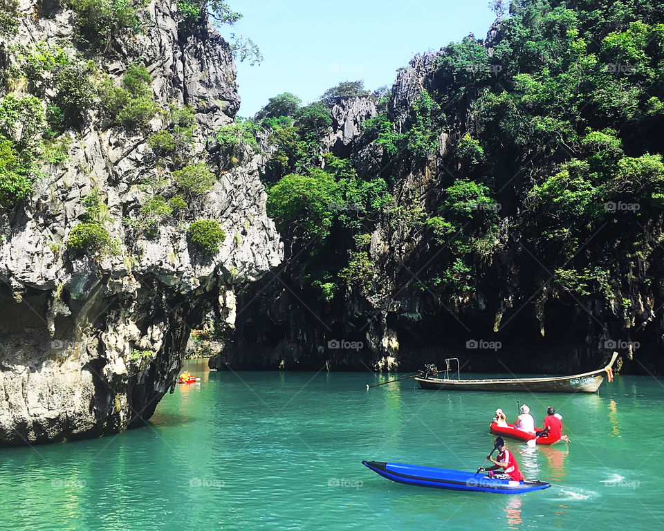 Swimming in boats under the tropical rocks