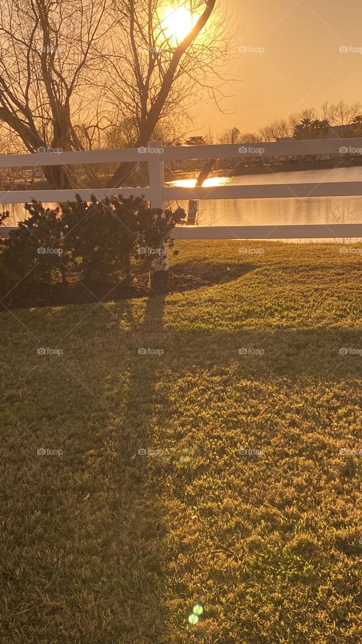 Orange yellow backlit Sky. Sundown not much reflections water. No intense moments with this Sunset. Atmosphere already chilled from strong Cold Front earlier this week.
