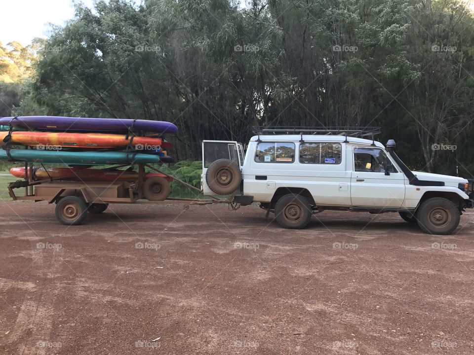 Taking the colorful kayaks down to the river. 