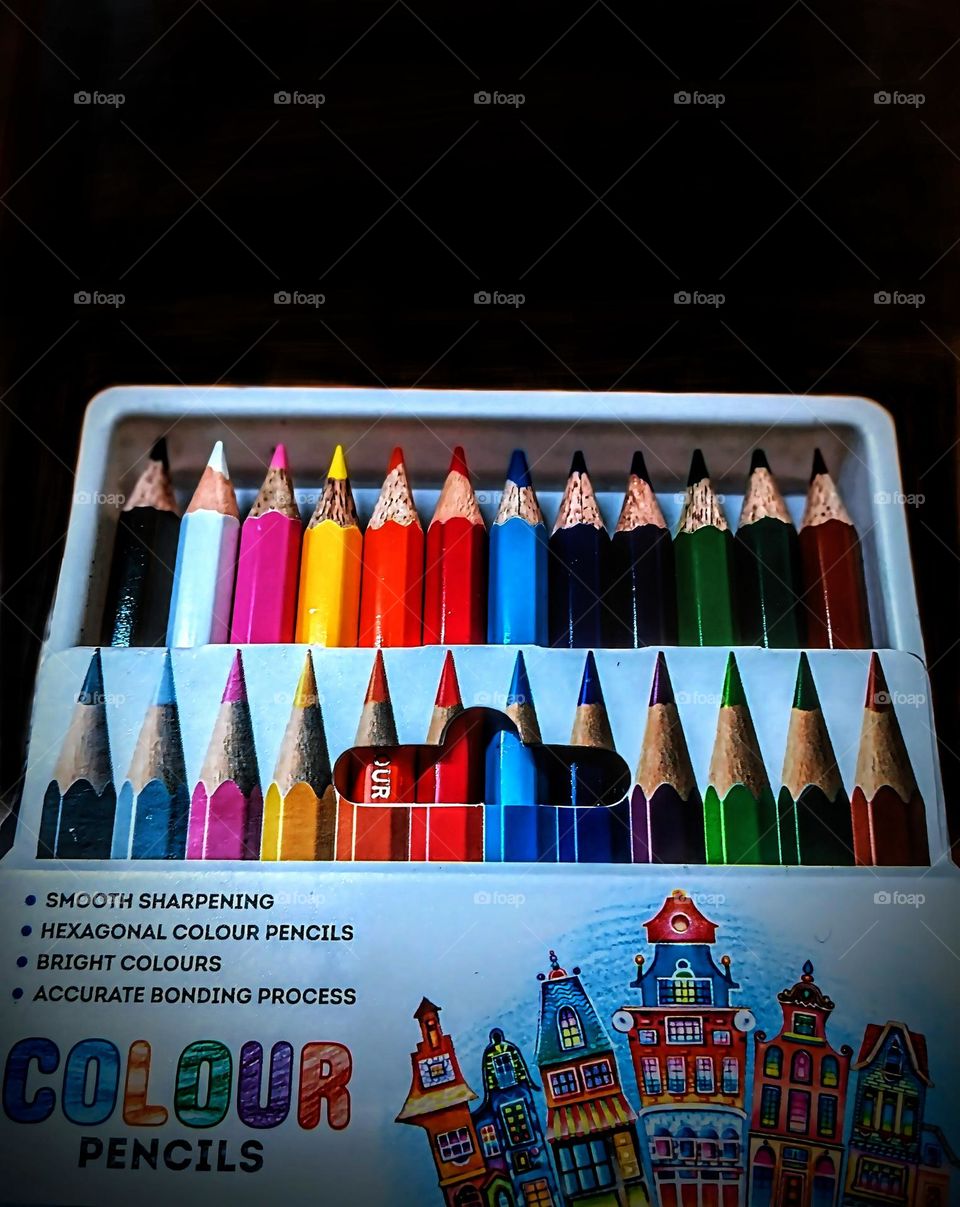 close-up of neatly arranged hexagonal color pencils, showcasing vibrant hues, sharp tips, and a glossy finish.The composition enhances the visual appeal, making the colors pop while reflecting creativity and artistic inspiration.