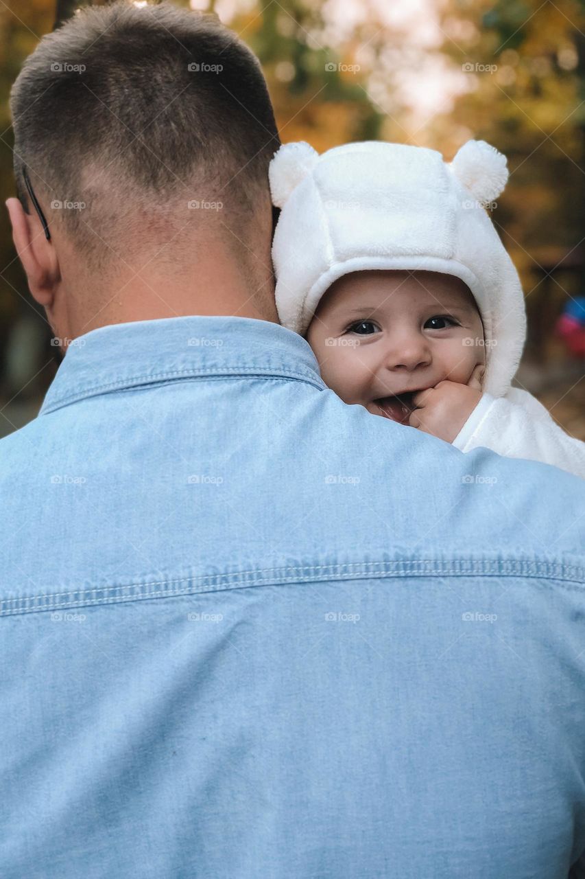 Smiling baby in the dad arms