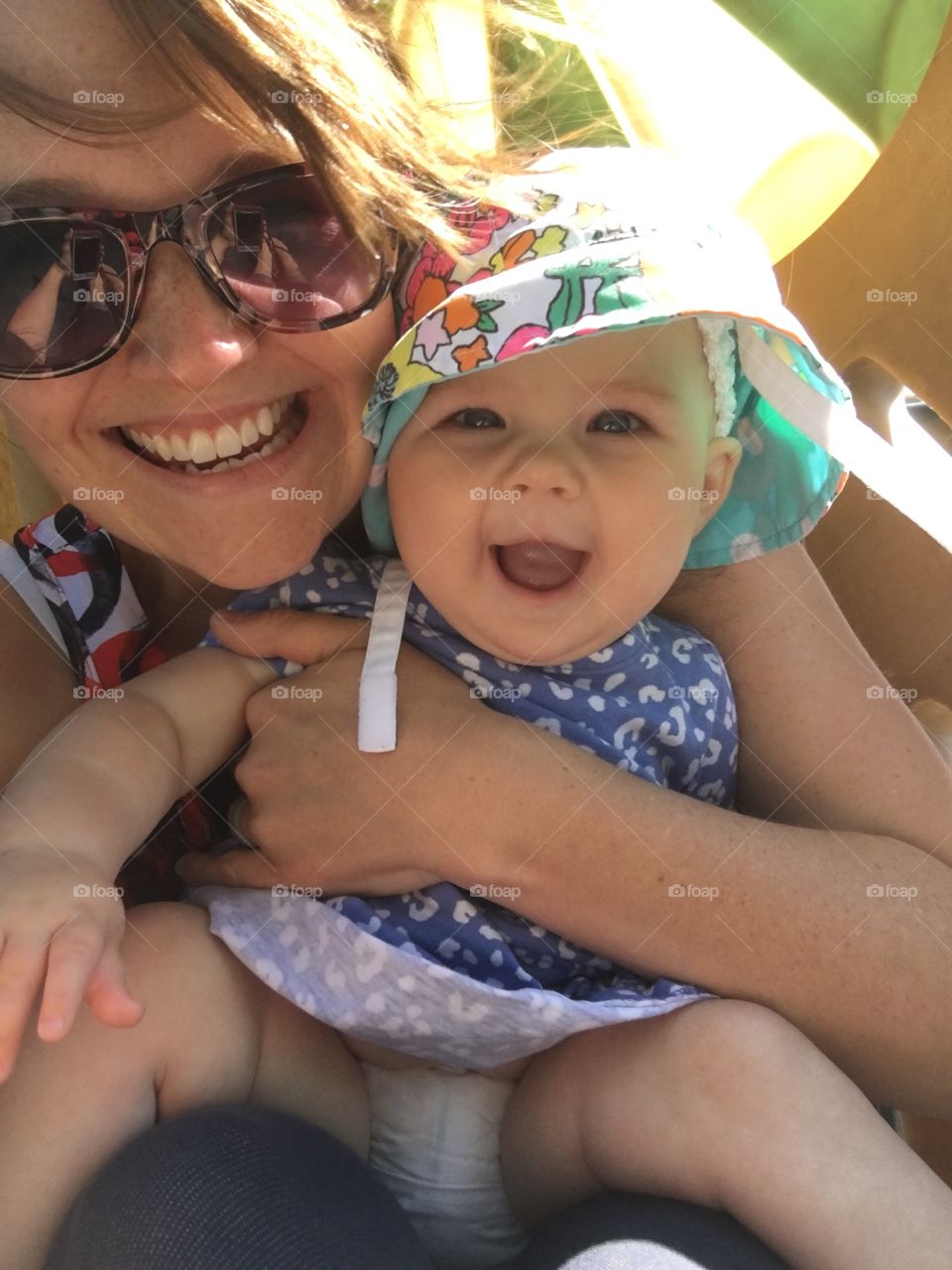 Close-up of mother holding daughter and smiling