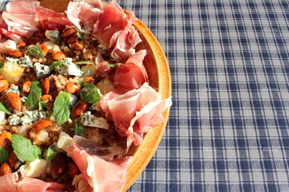 Close-up of dried fruit and meat in wooden bowl