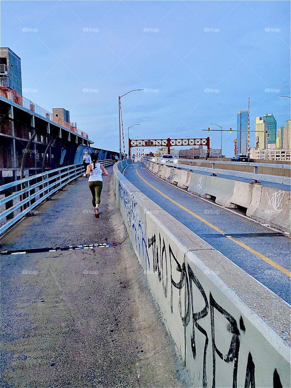 This is the pedestrian lane of the “Pulaski Bridge” at “Newtown Creek” in LIC, Queens crossing over from the “Greenpoint”, Brooklyn side of the bridge on a warm sunny Indian summer afternoon in early October 2023. Hypnotic Productions