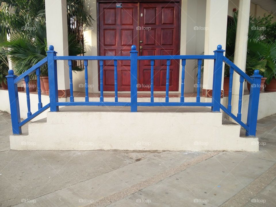 white stairs and blue handrail