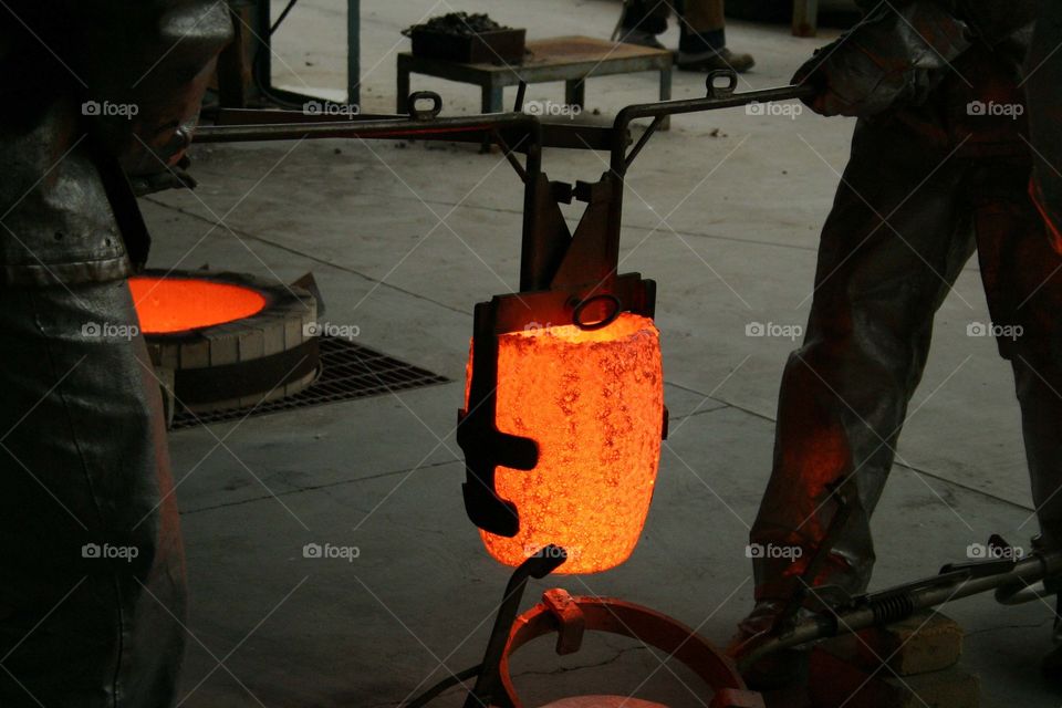 Carbide graphite crucible heated to over 2200 degrees to melt bronze for a bronze pour.