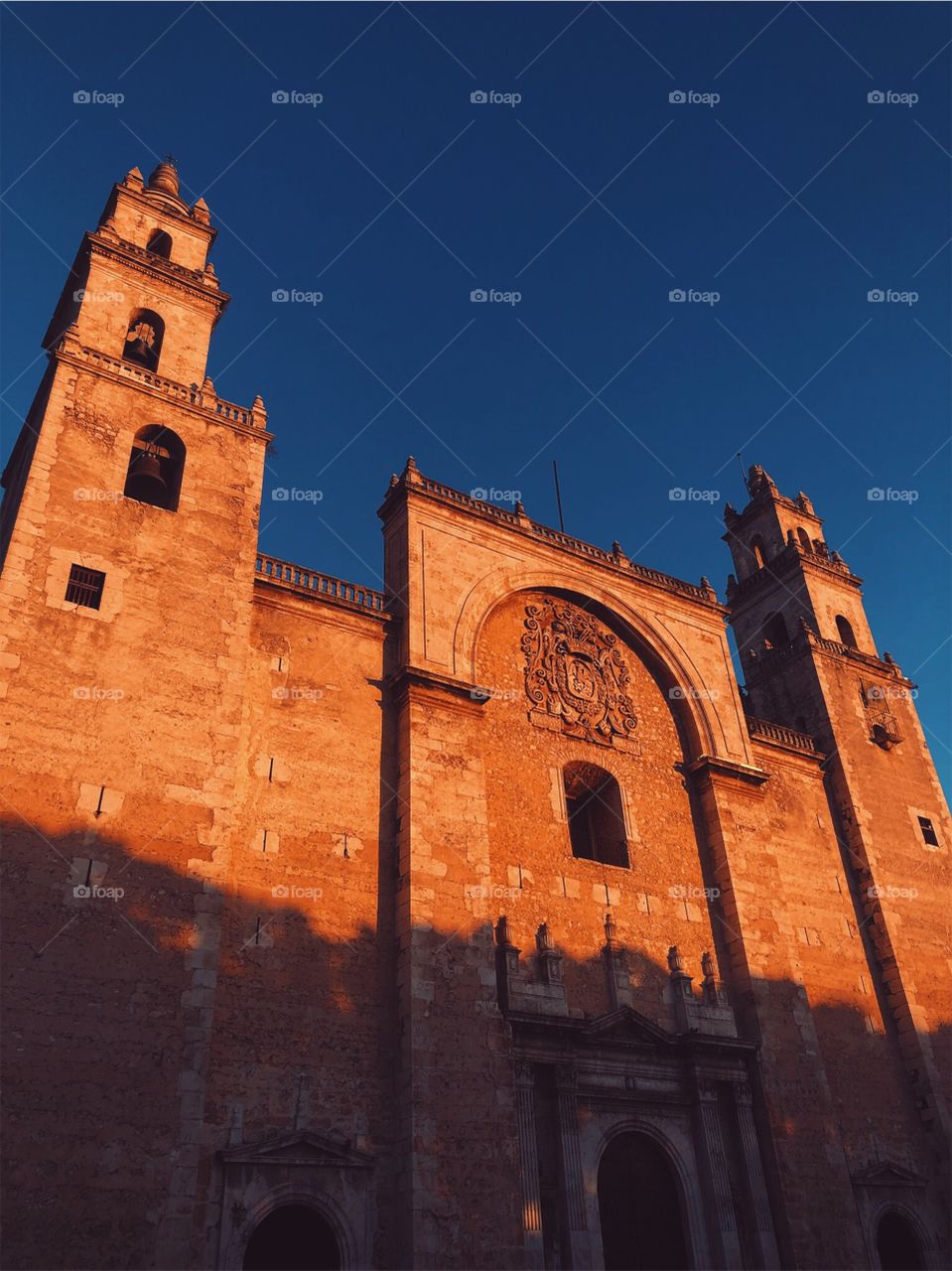 Mexico City, Mexico. The sun sets & reflects onto this building for a wonderful picture of blue & orange alike.