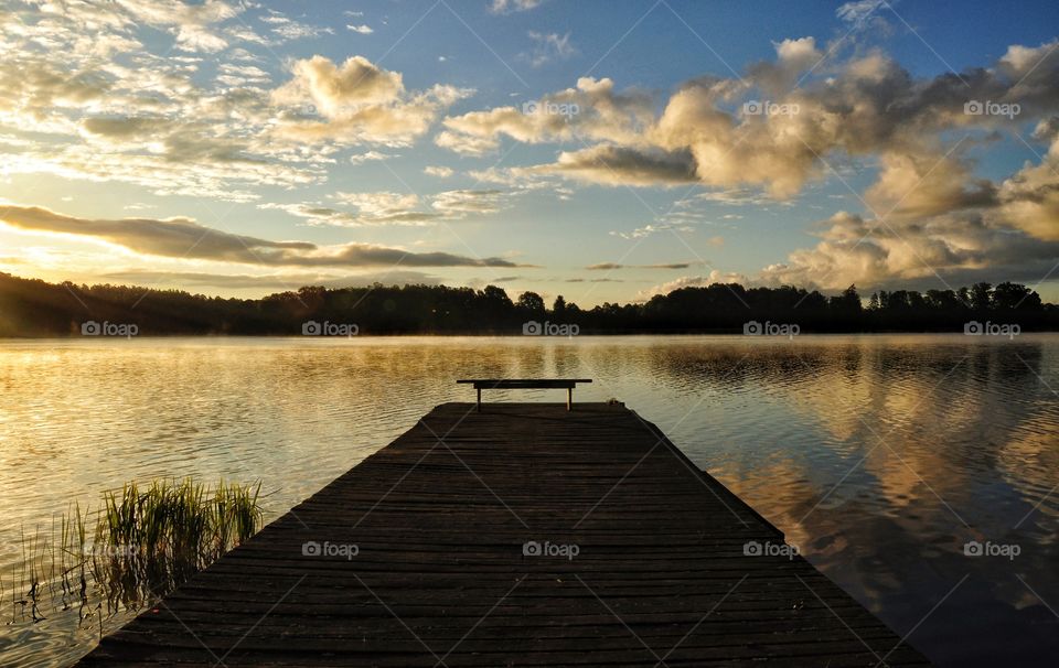 sunrise over the lake in boreczno with empty wooden pier