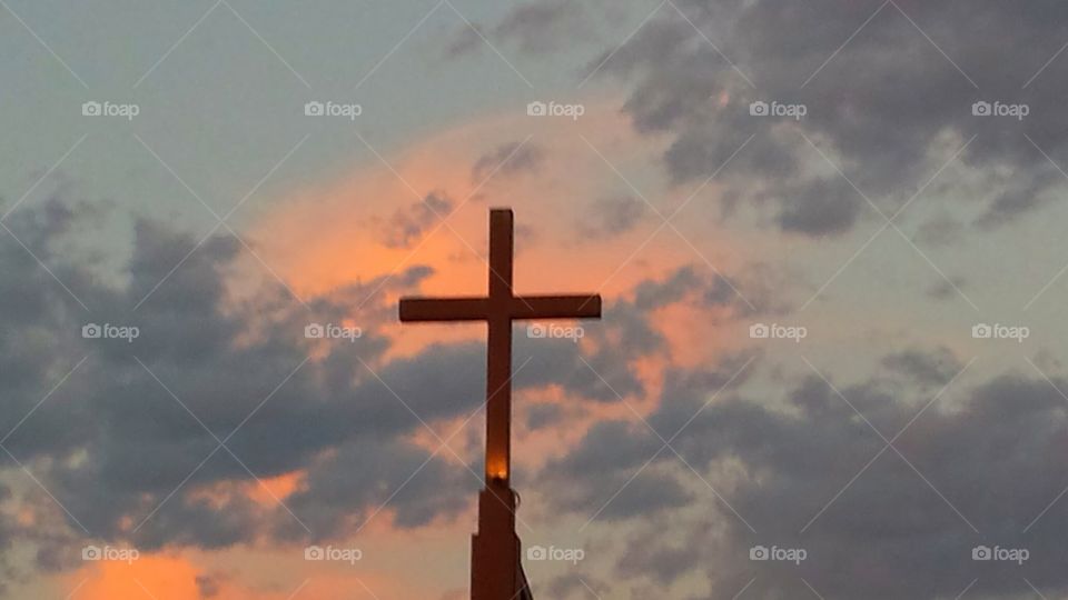 Cross upon a Steeple with Sunset Background