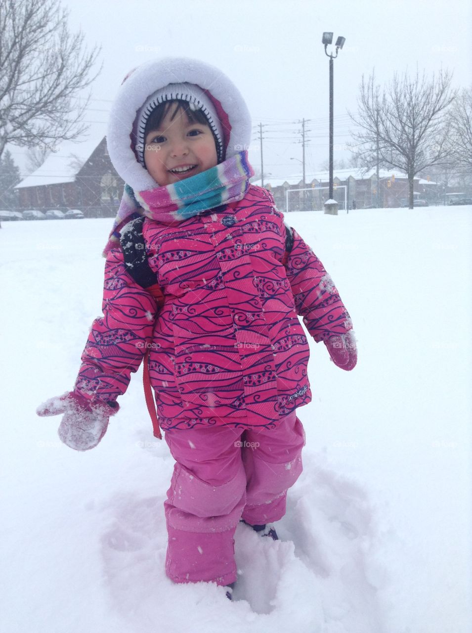 Cute girl standing on snowy land