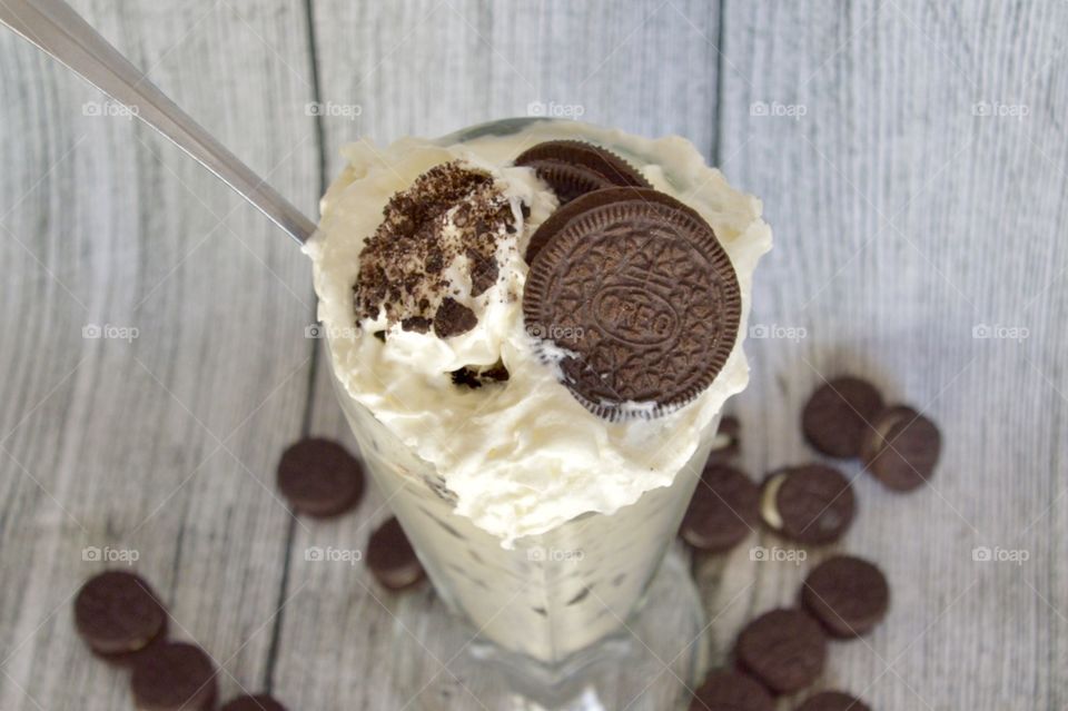 Oreo cookie milkshake with a wooden rustic white background