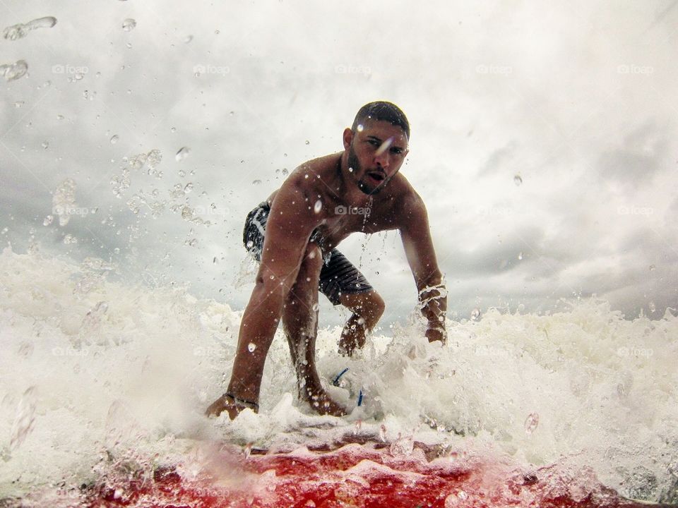 Close-up of a man surfing on sea wave