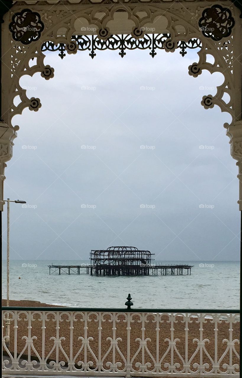 Decorative view of burnt ruins of Brighton pier seen from Victorian bandstand 