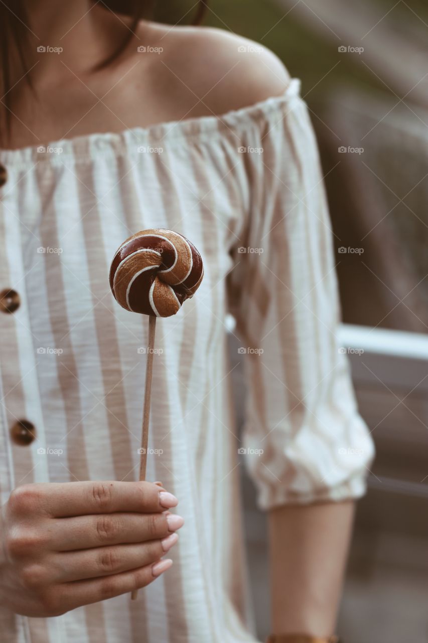 Elegant girl with sweet lollipop 