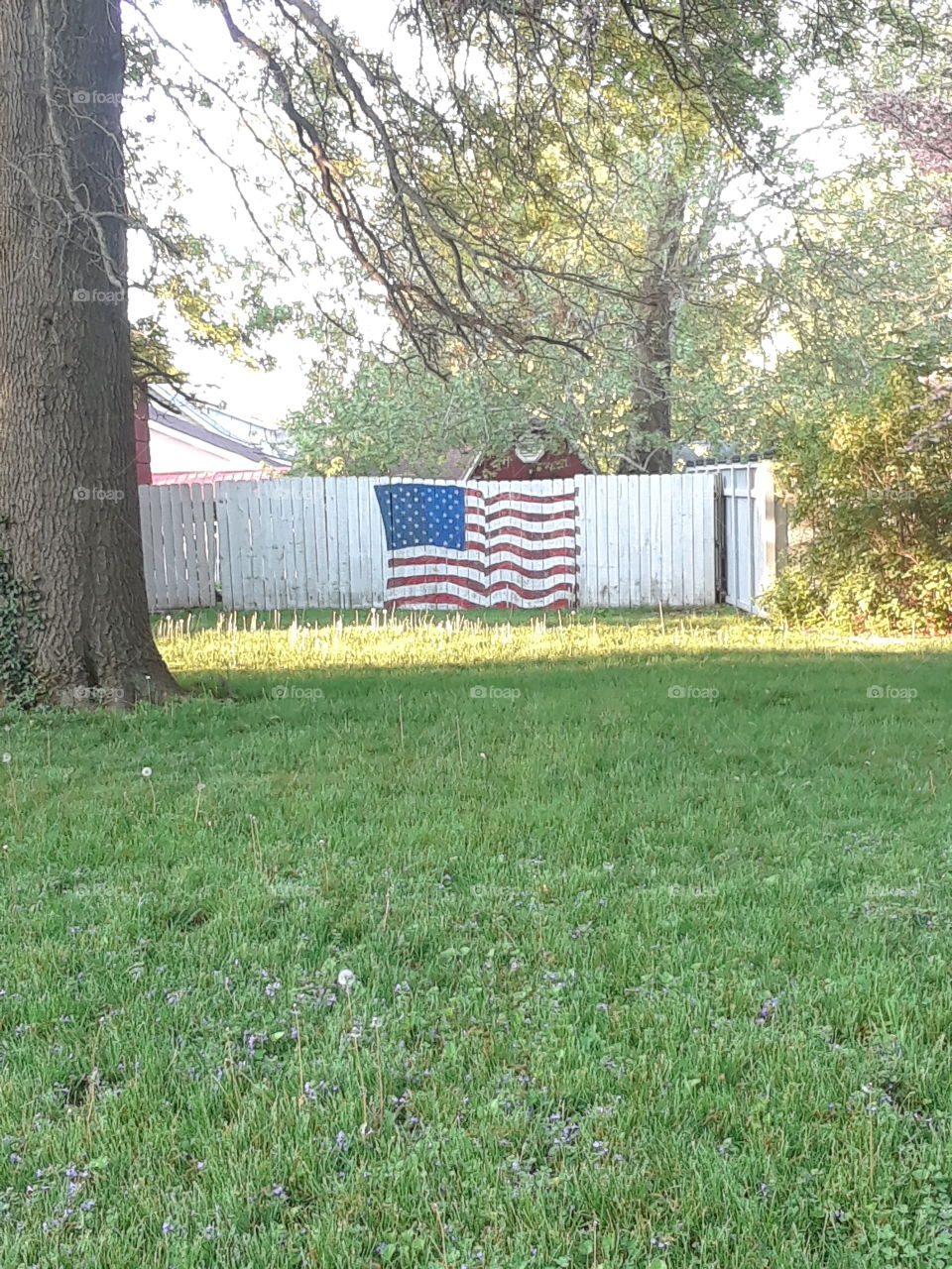 American Flag painted on a white fence