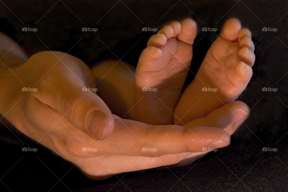 My favorite photo baby’s feet held in father’s hands 