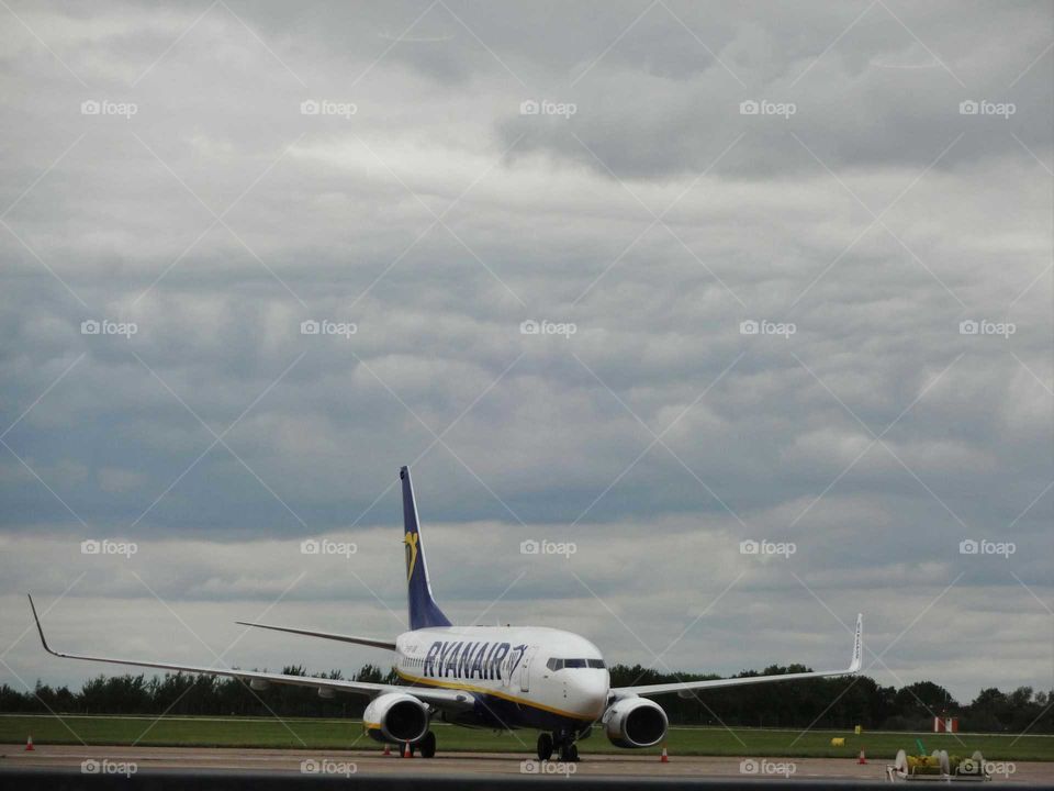 airplane with cloudy sky in the background