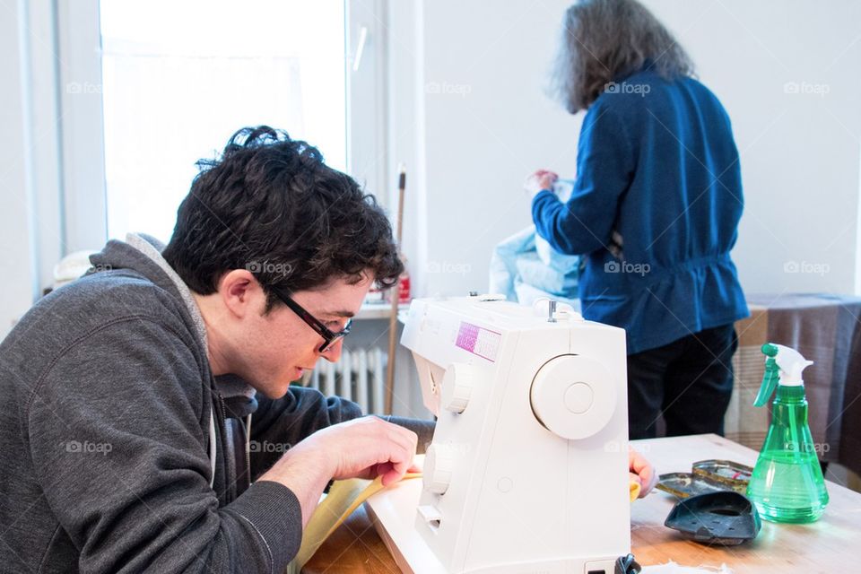 Man learning to sew