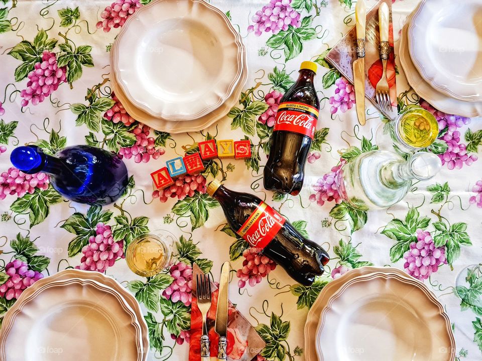 set table photographed from above with Coca Cola bottles and Always writing