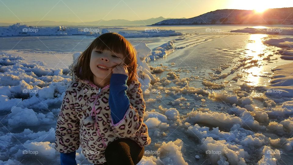 Girl sitting on beach in winter season