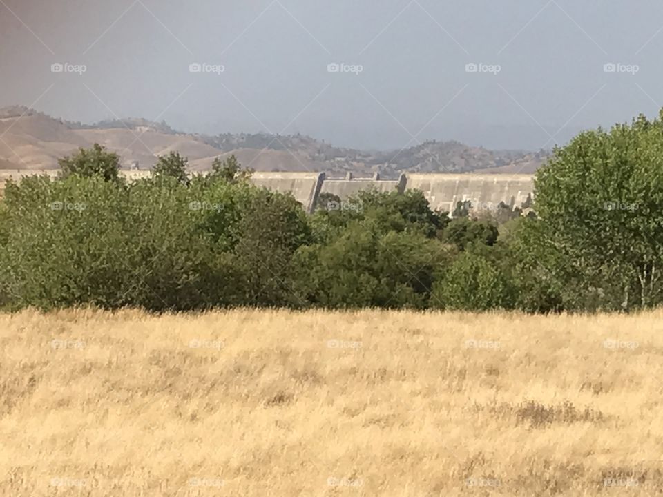 Lost Lake Recreation Area. It is absolutely an ample open field covered with tall dry grass. There are even large trees that stand out for your admiration. Way far in the background is Friant Dam.