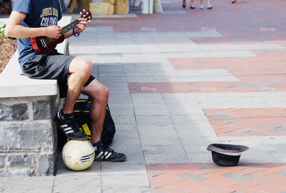 As we were enjoying an outdoor festival this kid was busking, both singing and playing on his ukulele, and doing tricks with the soccer ball. A very talented young man! 