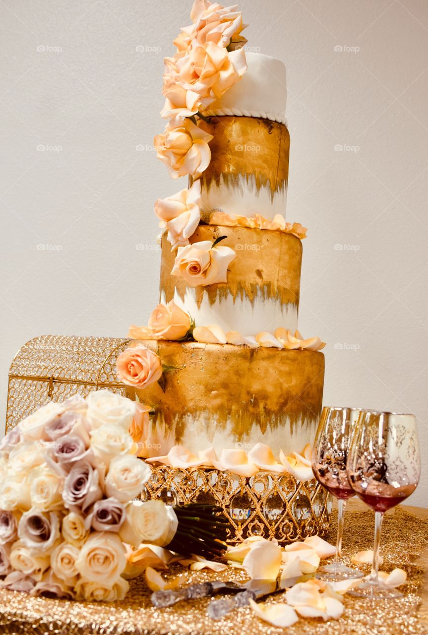 A Triple Layer Golden wedding cake with flowers 