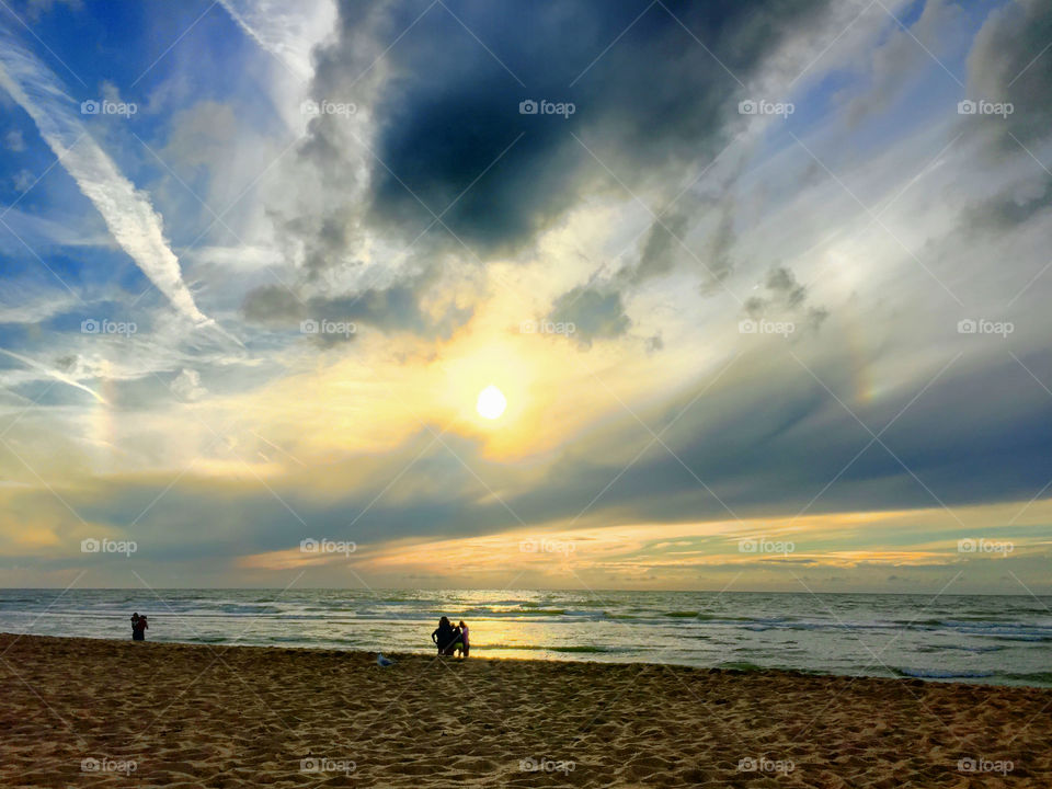 Walking at the beach at sunset