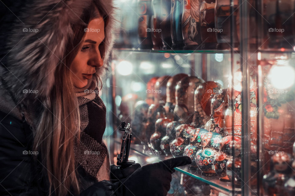 Woman looking at souvenir in store