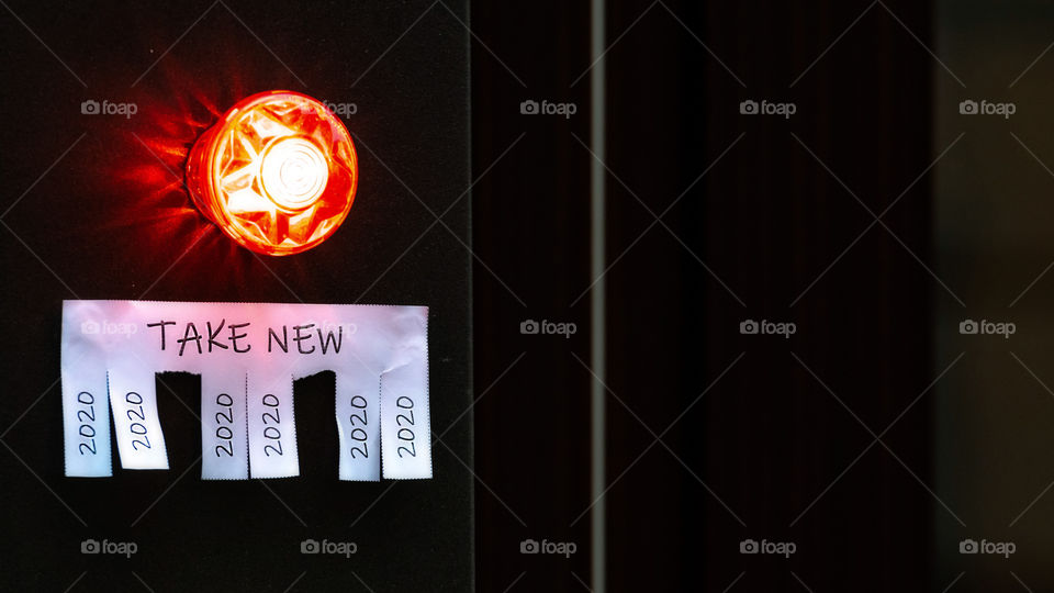 shop doors with paper with the phrase: Take New and with a 2020 sign ready to be tore off,