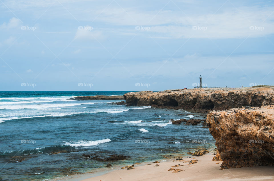 Beach and seashore with a lighthouse 