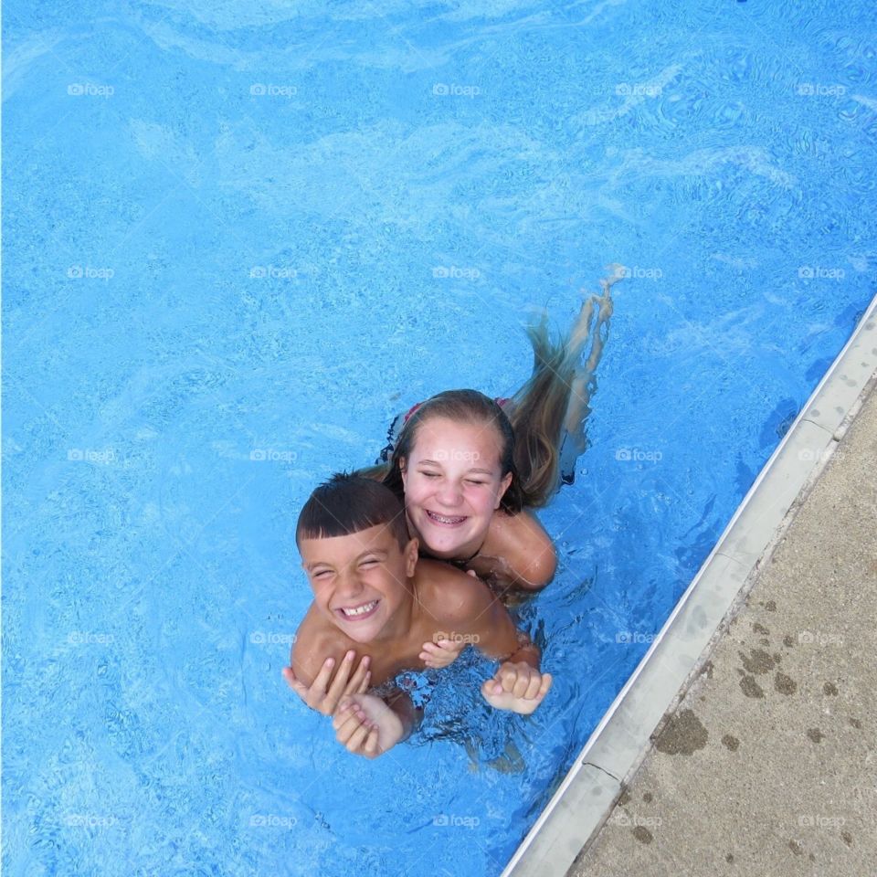 Big smiles from kids in pool